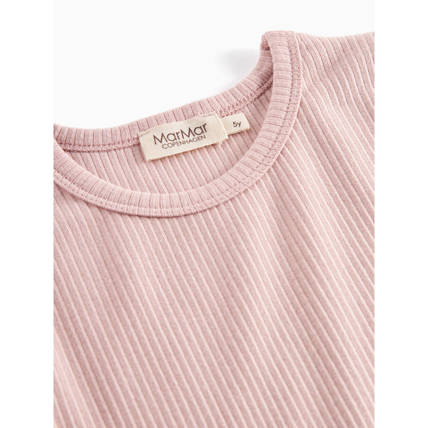 Close-up of a ribbed pink garment with a visible brand tag on a white background