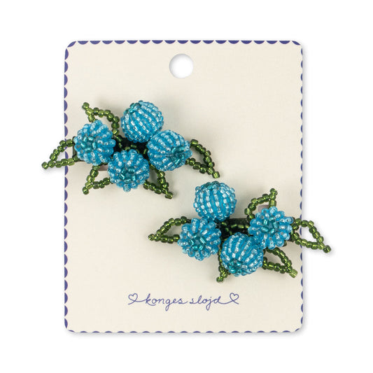 Pair of blue beaded earrings on a branded card against a white background