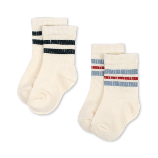 Two pairs of cream socks with colorful stripes on a white background