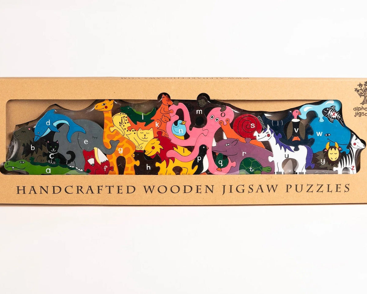 Box of handcrafted wooden jigsaw puzzles with animal designs on a white background