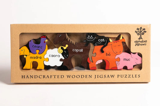 Box of handcrafted wooden jigsaw puzzles with animal illustrations on a white background