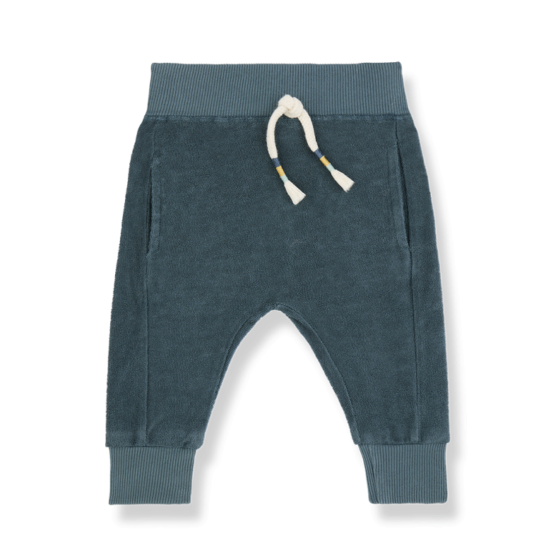 A pair of soft, blue-green baby jogger pants made of plush fabric. The pants feature a ribbed elastic waistband with a cream-colored drawstring, accented with small striped details. They have two side pockets and ribbed cuffs at the ankles for a snug and comfortable fit, perfect for casual wear.