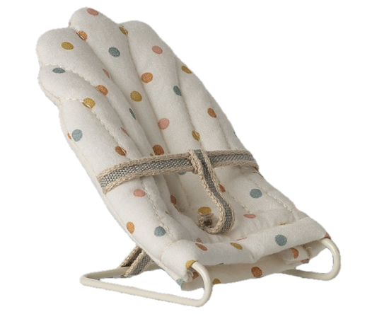 Baby bouncer with colorful polka dot pattern on a white background