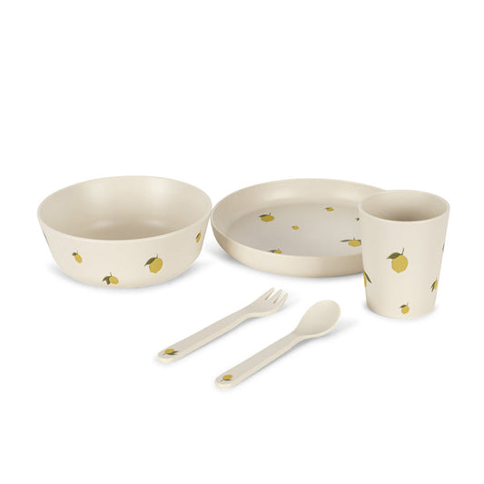 Set of children's tableware with bowls, plate, cup, fork, and spoon on a white background. Knoges Slojd