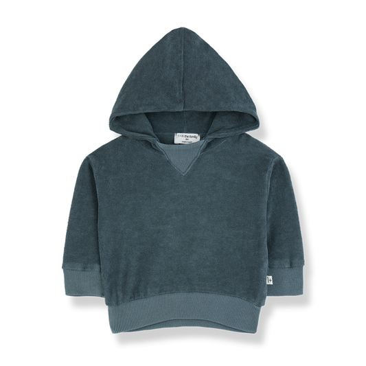 A children's hoodie in a muted blue shade, made from a soft, plush fabric. It features a large hood, ribbed cuffs, and a ribbed hem for a snug fit. The design is minimalistic and cozy, perfect for casual wear.