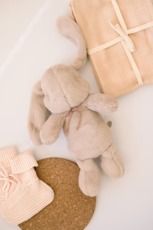 A gift bundle for new baby with muslin teddy and booties
