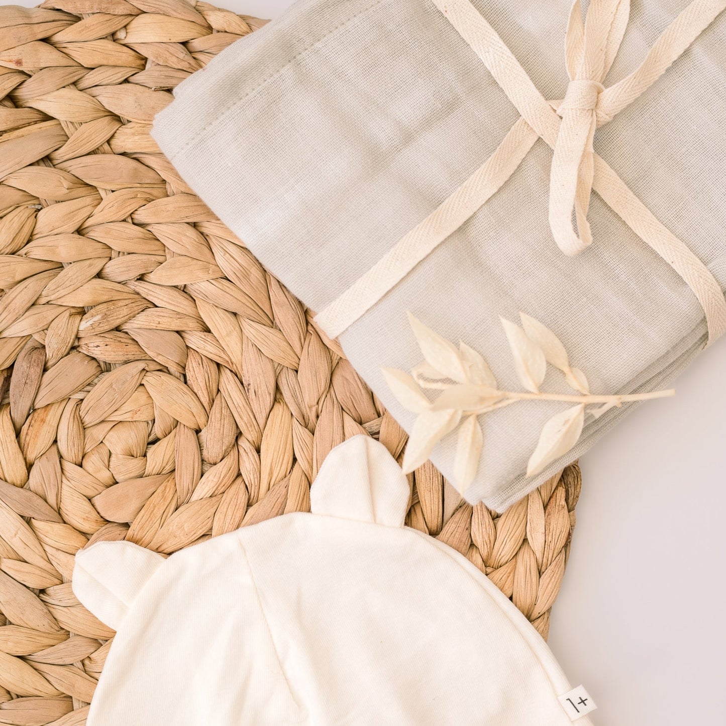 A newborn baby gift set, with a hat and muslin cloth