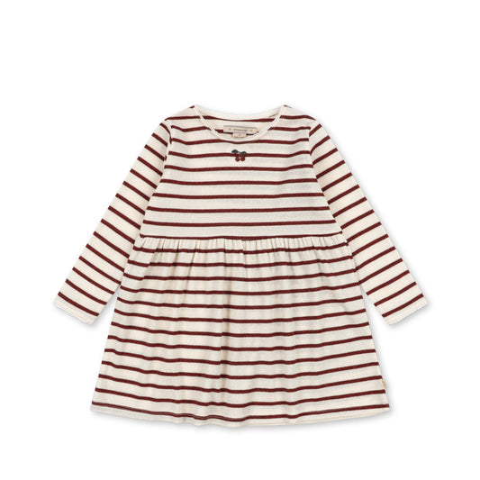 A long-sleeve baby dress with horizontal rust red and cream stripes, featuring a gathered waist and a small bow at the neckline, shown on a plain white background.