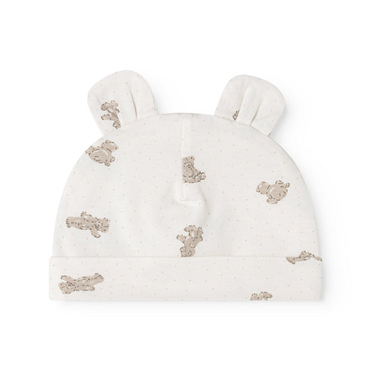 An off-white knit baby hat with small ear tufts and an allover print of teddy bears in a muted brownish-gray color, shown against a plain white background.