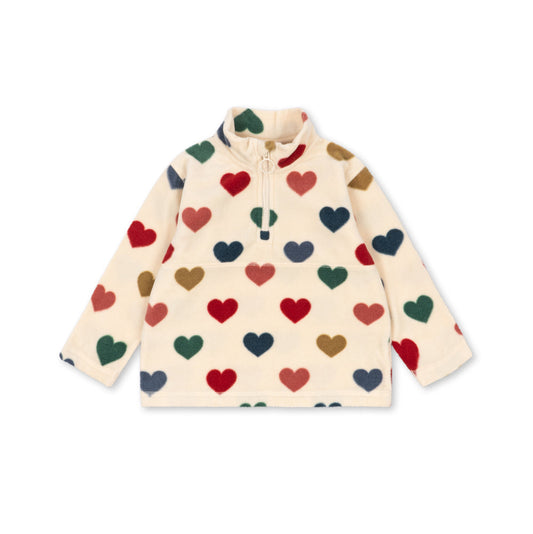 A cream-colored long-sleeve quarter-zip fleece pullover with an all-over pattern of small hearts in red, green, navy, and brown, displayed flat against a white background.