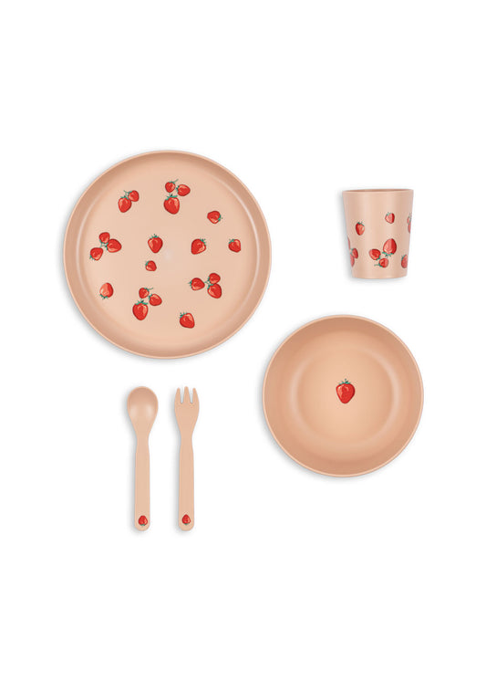 Children's tableware set with plates, cup, cutlery, and strawberry pattern on a white background