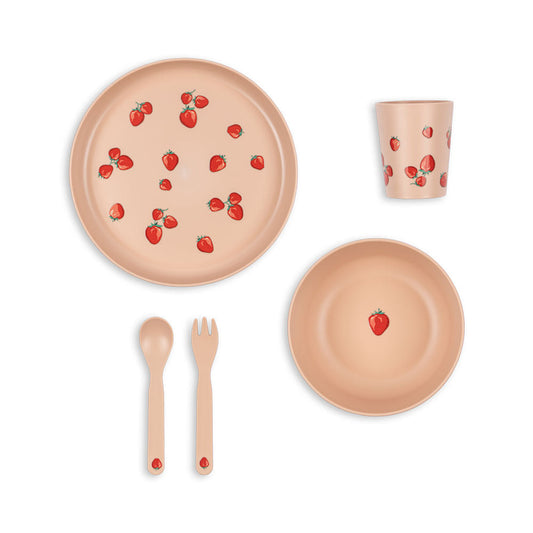Children's tableware set with plates, cup, cutlery, and strawberry pattern on a white background