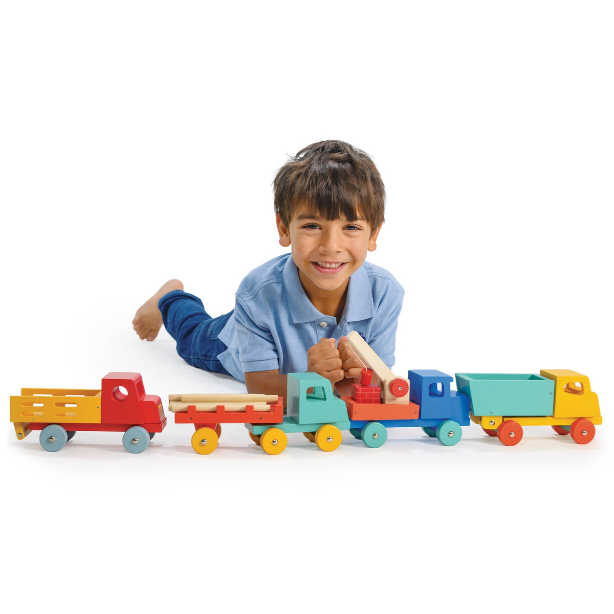 Child playing with a colorful toy train set on a white background