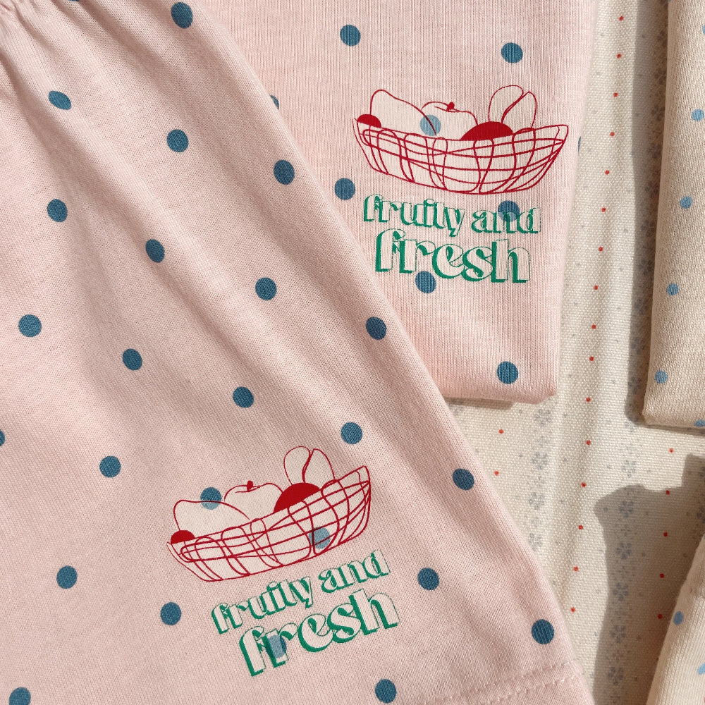 Pink fabric with blue polka dots and 'Fruity and Fresh' text design.