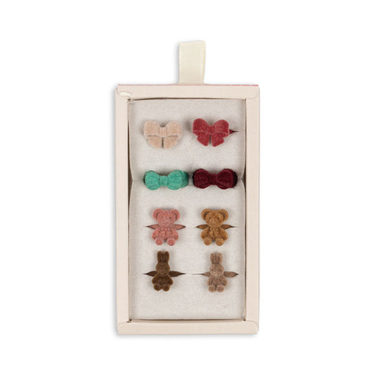 Set of colorful hair accessories in a box on a white background.Konges Slojd