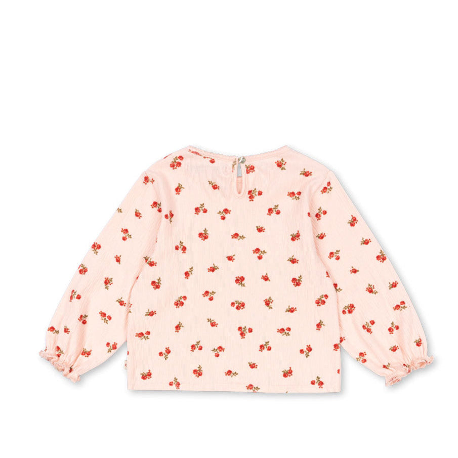Pink children's sweatshirt with red floral pattern on a white background