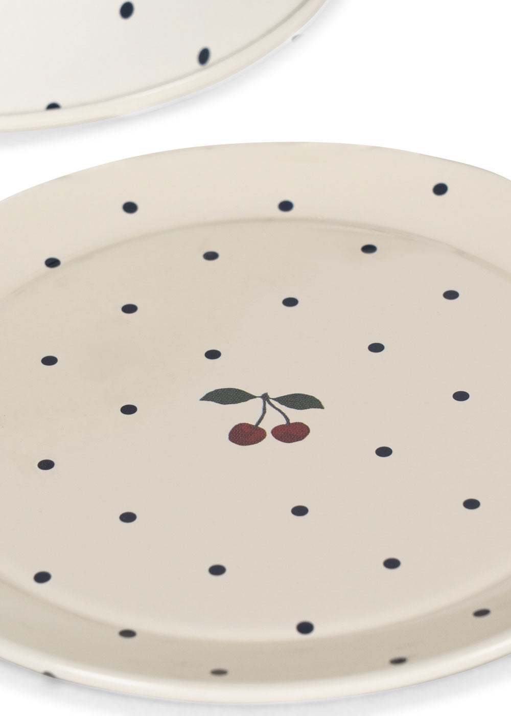 Beige ceramic plate with black polka dots and cherry design on a white background