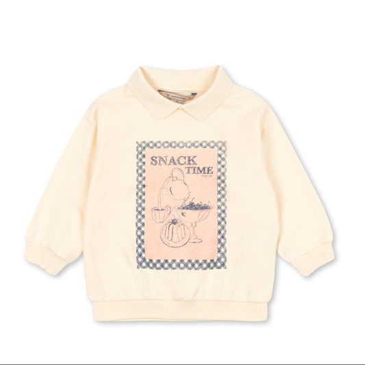 Light pink sweater with graphic design on a white background