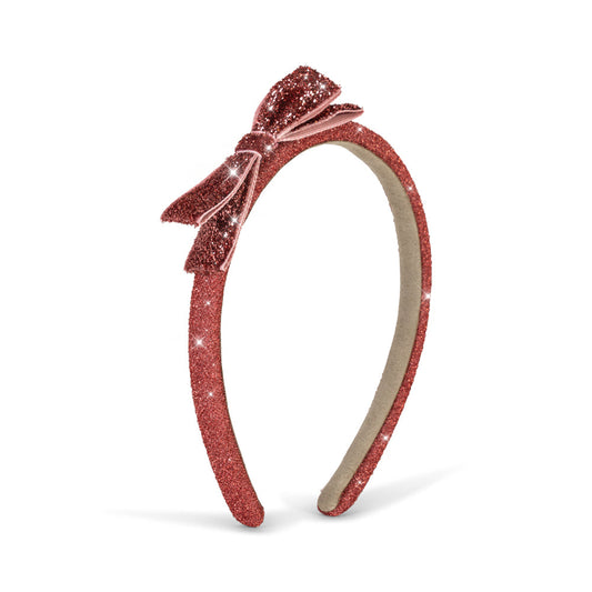 A glittery red headband with a matching bow on top, shown against a plain white background.
