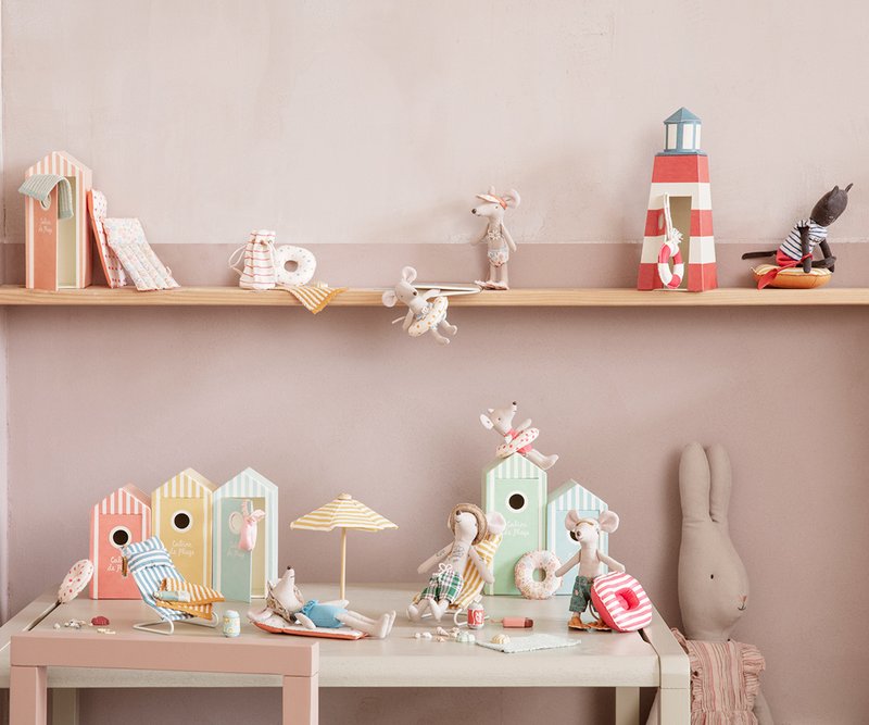 Children's room with shelves and desk featuring toys and decorative items.