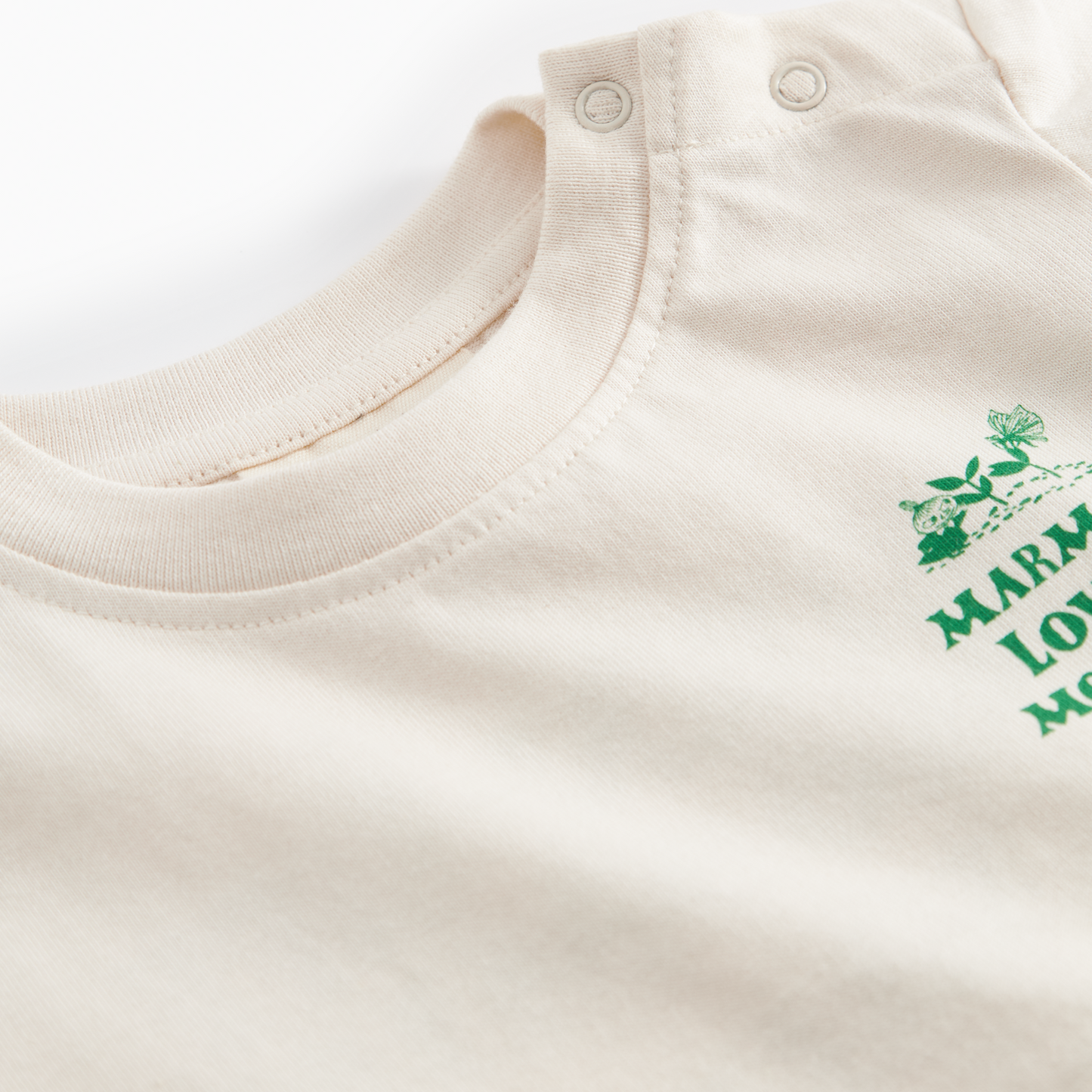 Beige baby onesie with green text on a white background