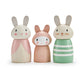 A set of three wooden bunny doll figures in different colors, designed for children's playsets.