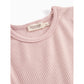 Close-up of a ribbed pink garment with a visible brand tag on a white background