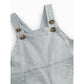 Light blue denim overalls with wooden buttons on a white background