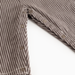 Close-up of a brown and white striped shirt with buttons on a white background
