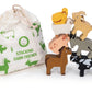 A children's stacking toy set featuring wooden farm animals and a matching fabric drawstring bag. The set includes a brown horse, black-and-white cow, gray donkey, pink pig, beige sheep, yellow chicken, tan goat, and a white goat, with the bag printed in green with the text 'STACKING FARM FRIENDS'.