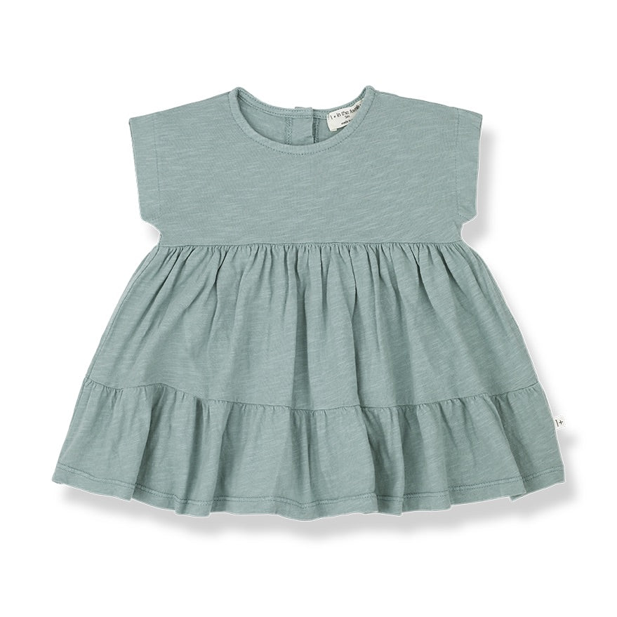 A light cotton siummer dress with short sleeves and ruffles on the skirt.Made from orgaic cotton.