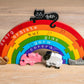 Colorful rainbow-shaped puzzle with animal figures and text on a wooden surface