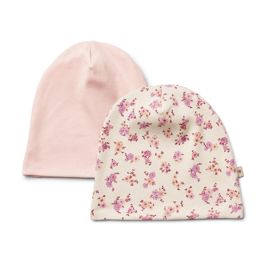 Two pack of girls beanies one pink one floral, made from GOTs certifed organic cotton, Made by Wheat, available on line or in store fromSonny Bear