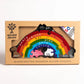 Handcrafted wooden rainbow puzzle in packaging with 'alphabet jigsaws' branding.