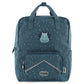 A blue Trixie kids backpack featuring a dinosaur design with a smiling triceratops, 3D dino spikes, and a front pocket.
