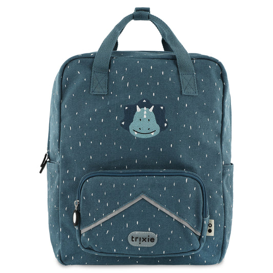 A blue Trixie kids backpack featuring a dinosaur design with a smiling triceratops, 3D dino spikes, and a front pocket.