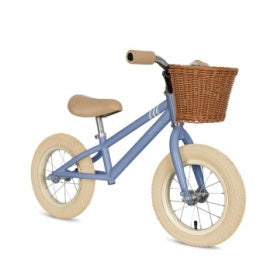 Children's balance bike with a basket on a white background