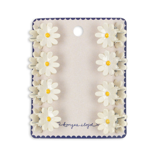 Set of daisy flower clips on a branded card against a white background