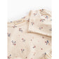 Floral patterned fabric with a brand label on a white background