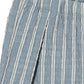 Close-up of blue and white striped organic cotton fabric with a textured pattern.