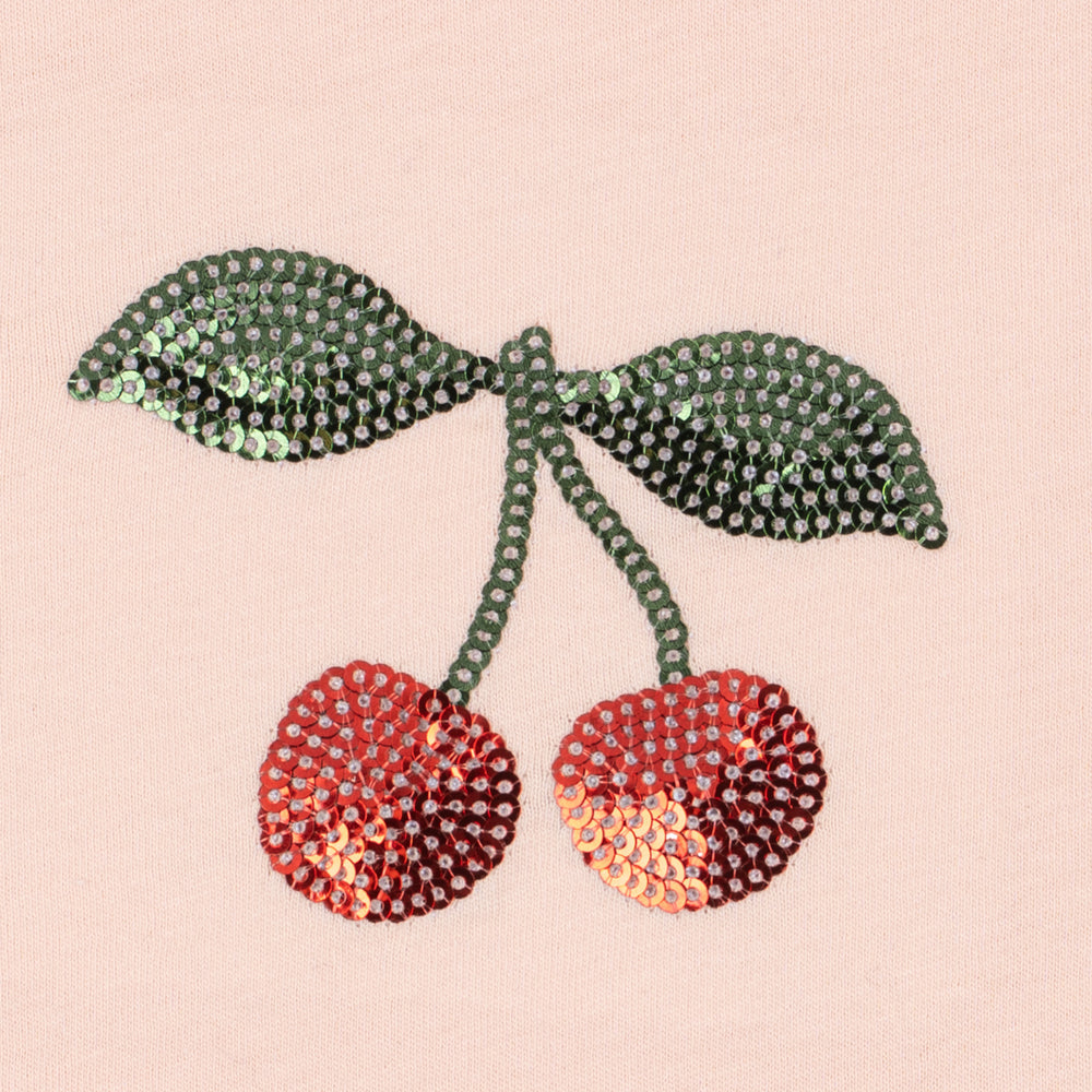 Decorative cherries made of rhinestones on a pink background