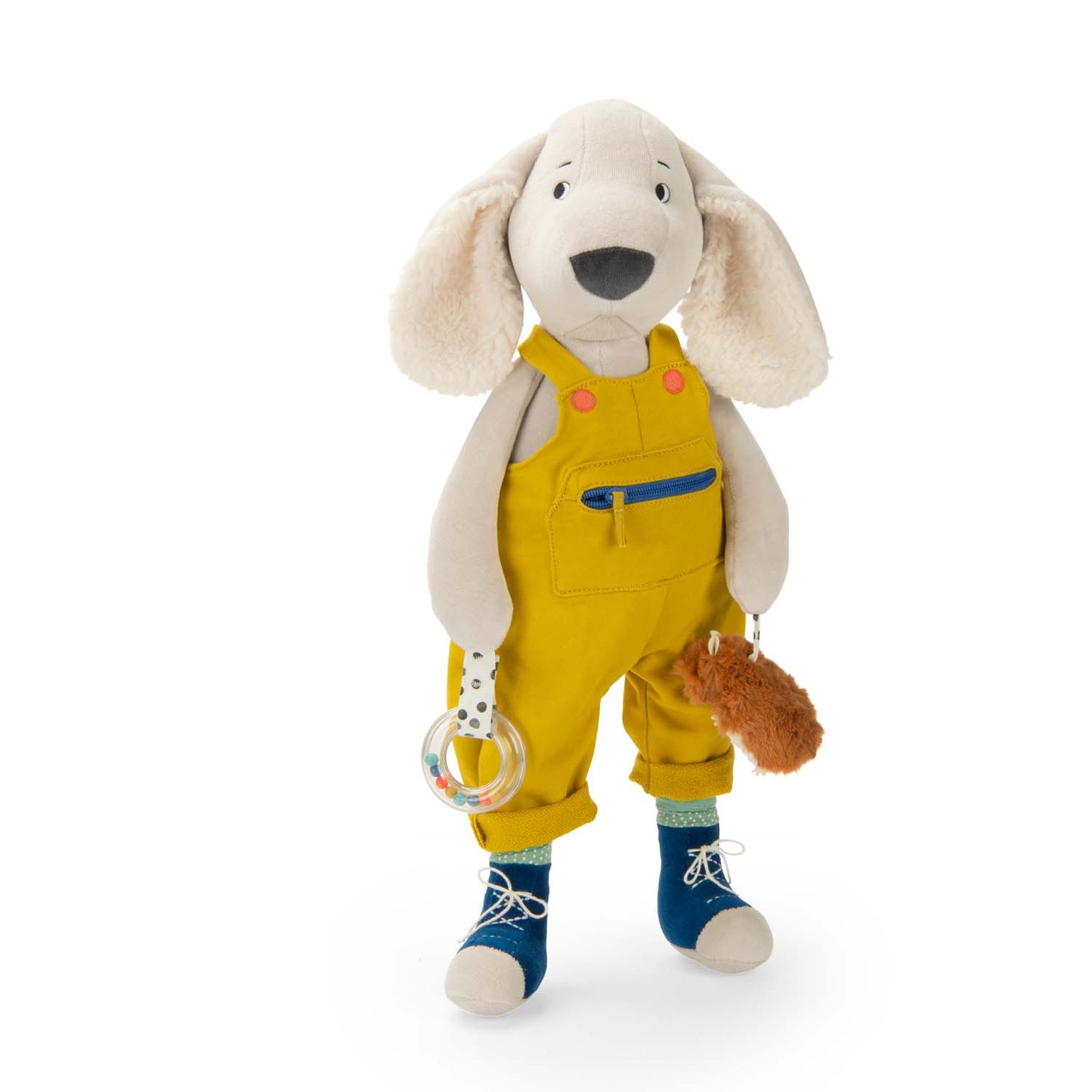 Stuffed dog toy in yellow overalls with a pacifier and rattle on a white background
