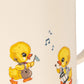 Mug with yellow duck illustrations playing instruments on a white background