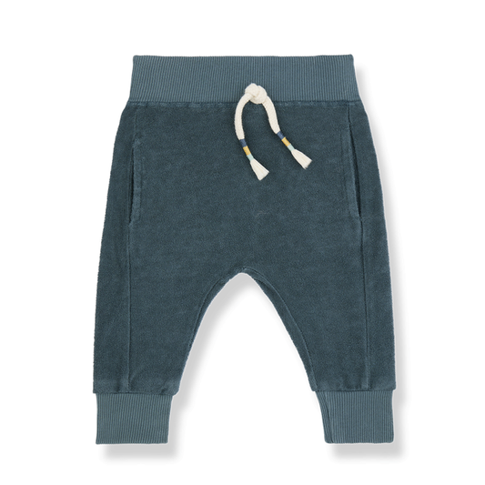 A pair of soft, blue-green baby jogger pants made of plush fabric. The pants feature a ribbed elastic waistband with a cream-colored drawstring, accented with small striped details. They have two side pockets and ribbed cuffs at the ankles for a snug and comfortable fit, perfect for casual wear.