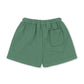 Green boys organic cotton shorts with a pocket on a white background