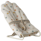 Baby bouncer with colorful polka dot pattern on a white background
