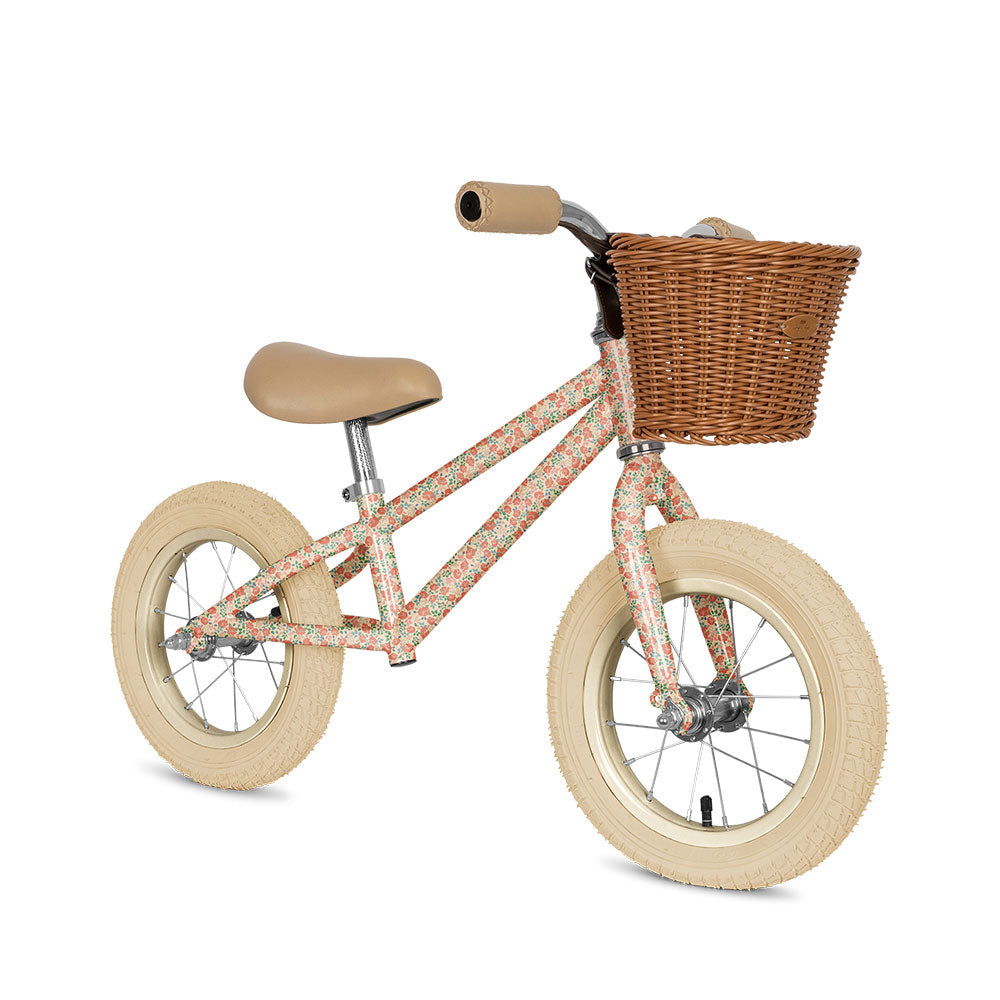 Children's balance bike with a basket on a white background.Knoges Slojd
