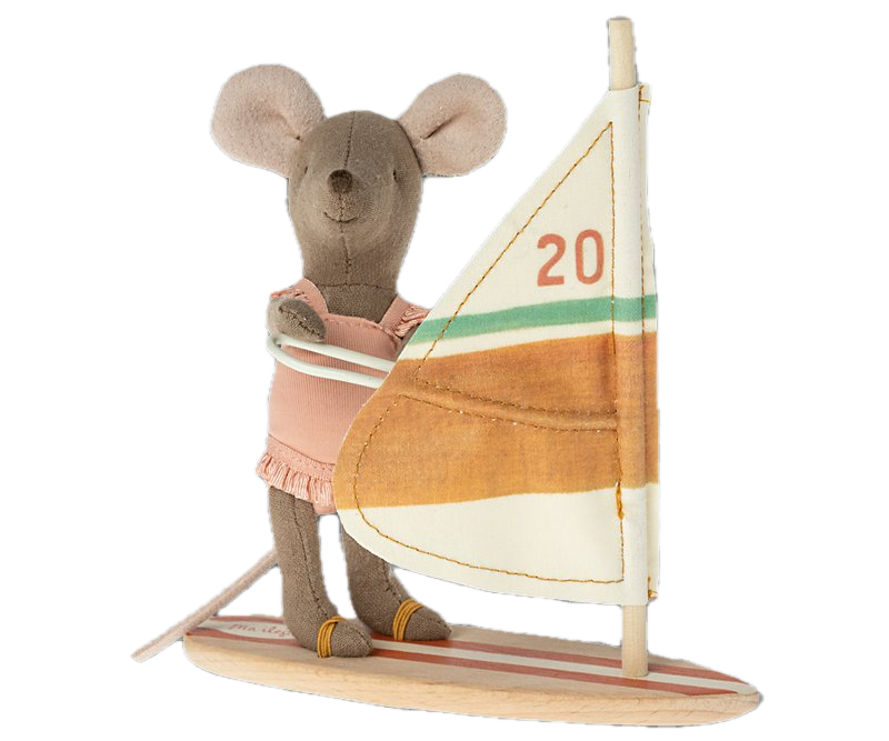Stuffed toy mouse on a sailboat with a colorful sail.