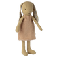 Knitted toy rabbit with a beige dress on a white background
