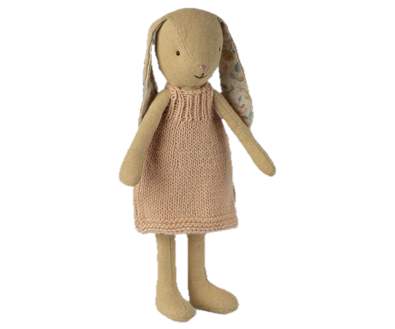 Knitted toy rabbit with a beige dress on a white background
